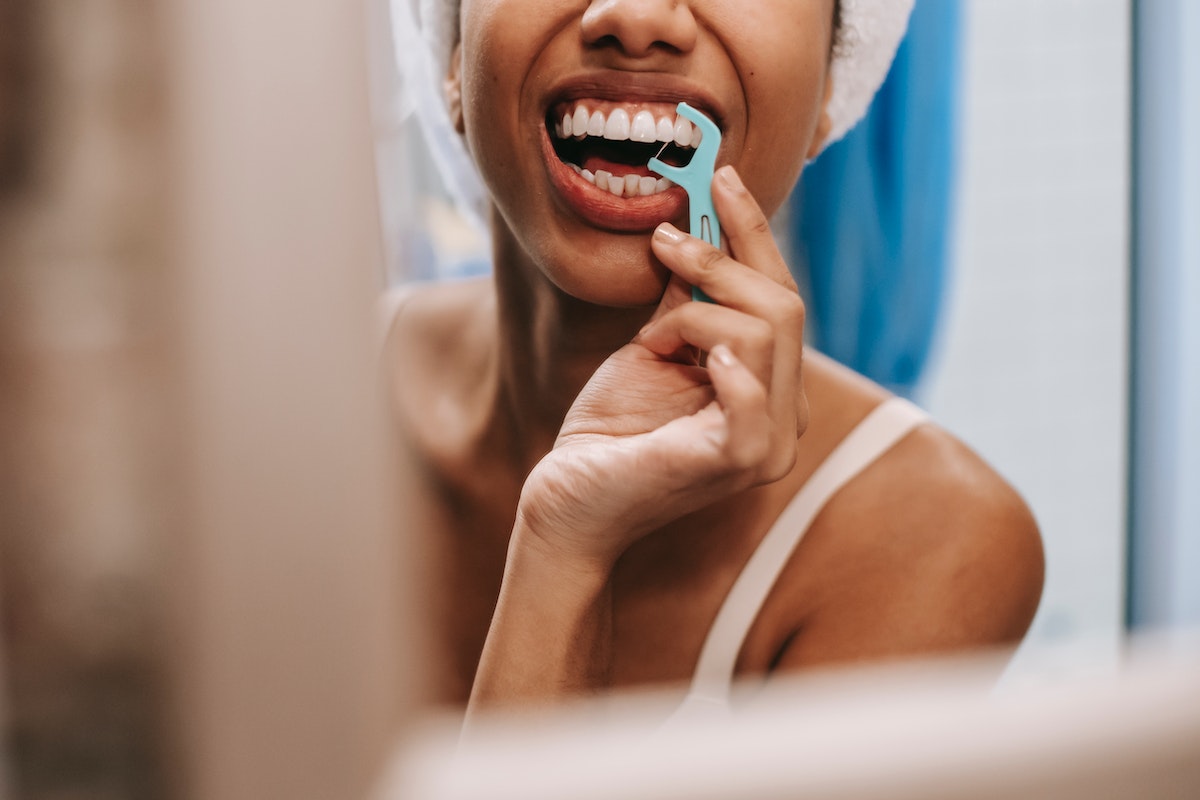 woman using dental floss.jpg